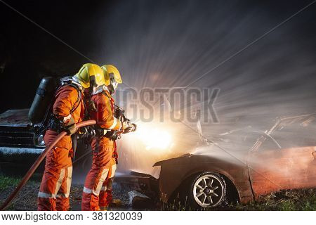 Firefighters Spraying Water To Put Out A Brutal Fire On The Car.