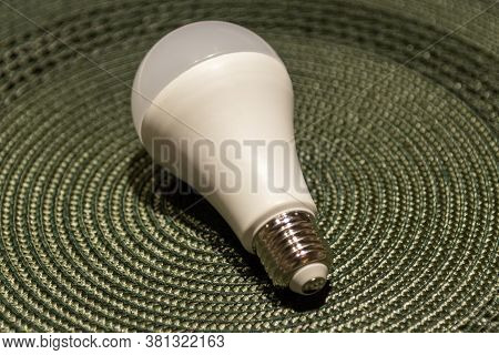 Peeled And Processed Rice Arranged In A Small Bowl. Wooden Scoop With Rice On A Blue Background. Hum