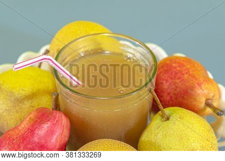 Pear Fruit Juice (pyrus Spp) On White Tray And Blue Background