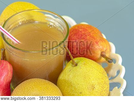 Pear Fruit Juice (pyrus Spp) On White Tray And Blue Background