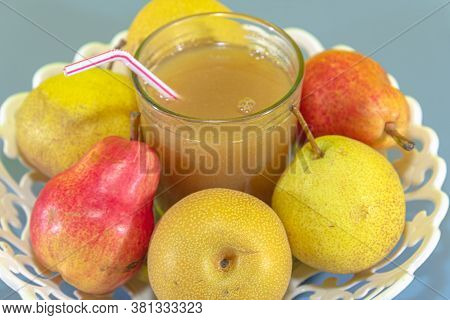 Pear Fruit Juice (pyrus Spp) On White Tray And Blue Background