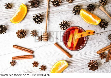 Christmas Mulled Wine With And Orange On Wooden Rustic Background. Selective Focus. Anise Stars And 