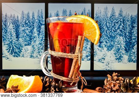 Mulled Wine Hot Christmas Drink With On A Windowsill, Next To The Window. Orange Slices, Cinnamon St
