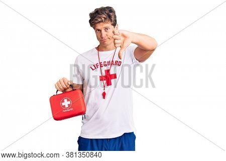 Young handsome man wearing lifeguard t shirt holding first aid kit with angry face, negative sign showing dislike with thumbs down, rejection concept 