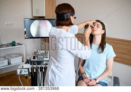 Female otolaryngologist and patient in office, exa
