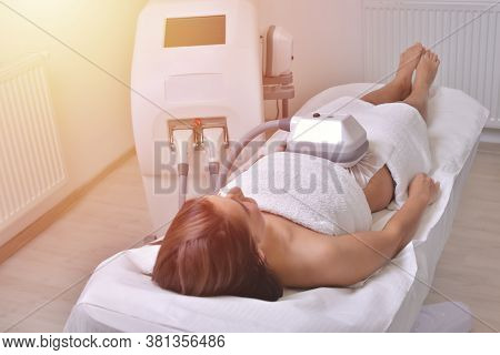 Beautiful Young Woman Getting Cryolipolyse Treatment In Cosmetic Cabinet