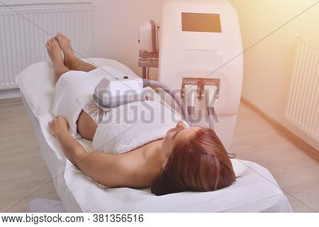 Beautiful Young Woman Getting Cryolipolyse Treatment In Cosmetic Cabinet