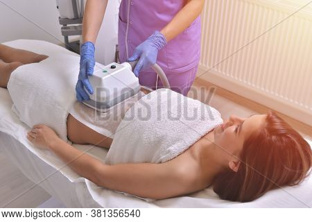 Beautiful Young Woman Getting Cryolipolyse Treatment In Cosmetic Cabinet