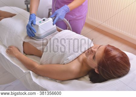 Beautiful Young Woman Getting Cryolipolyse Treatment In Cosmetic Cabinet
