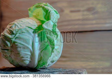 Head Of Fresh Cabbage (brassica Oleracea Var. Capitata) On Wooden Background