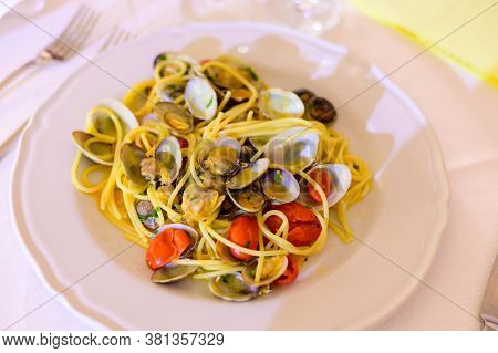Frech Homemade Spaghetti Pasta With Vongole Sea Sheels And Small Red Tomatoes Close Up
