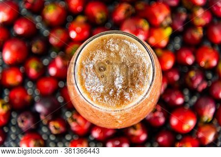 Glass Bowl Of Araçá Juice (psidium Cattleianum) With Fresh Fruits Around It