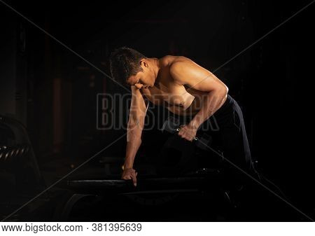 Handsome Man Raising Dumbbell,doing Exercise For Buit Muscle,fit And Firm Body,model Posing,blurry L