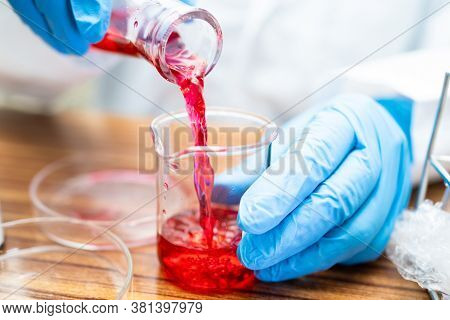 Erlenmeyer Flask, Conical Flask Glassware With Red Color Liquid Solution In Science Chemistry Labora
