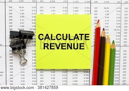 Text Calculate Revenue On Financial Tables With Color Pencils And Paper Clips
