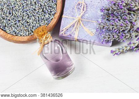 Lavender Natural Soap And Lavender Oil With Fresh Lavender Flowers And Dried Lavender Seeds On Rusti