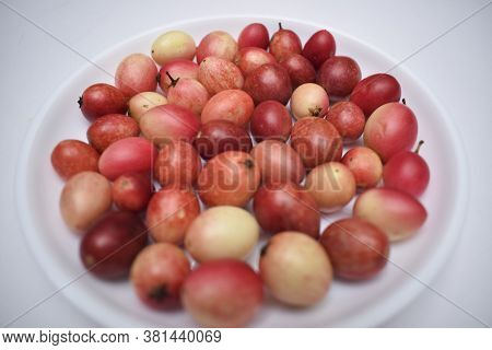 Selective Focus Of Indian Or Thai Exotic Fruit Carissa Caranda Arranged On Plate In White Background