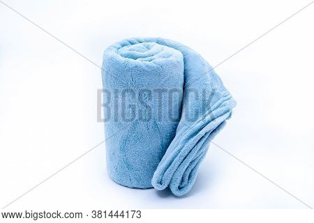 Rolled Up Blue Coral Fleece Throw Isolated On White Background