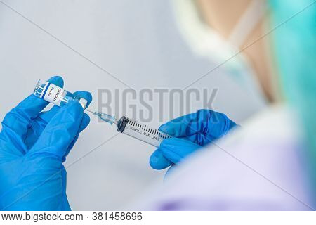 Doctor, Scientist, Researcher Hand In Blue Gloves Or Protective Suit Preparing For Human Clinical In