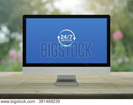 24 Hours Service Flat Icon On Desktop Modern Computer Monitor Screen On Wooden Table Over Blur Pink 