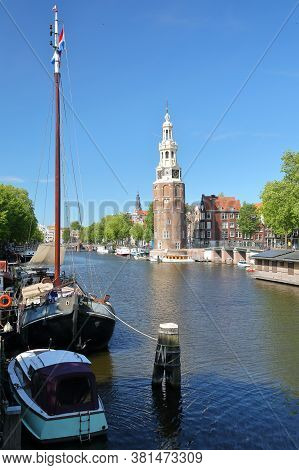 Montelbaanstoren Tower (built In 1516), Viewed Through Oudeshans Canal In Amsterdam Centrum, With Bo