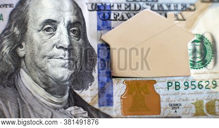 Mini Model House On Dollar Money Banknote Concept For Mortgage, Finance, And Saving