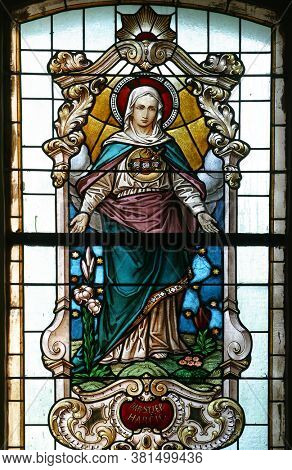 PESCENICA, CROATIA - SEPTEMBER 07, 2013: Immaculate Heart of Mary, stained glass window in Parish Church of the Assumption of the Virgin Mary in Pescenica, Croatia