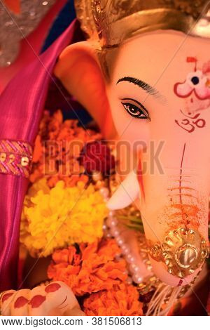 Abstract Background Of Lord Ganesha Beautiful Face & Eyes Close Up With Hindu Religion Om Sign Symbo