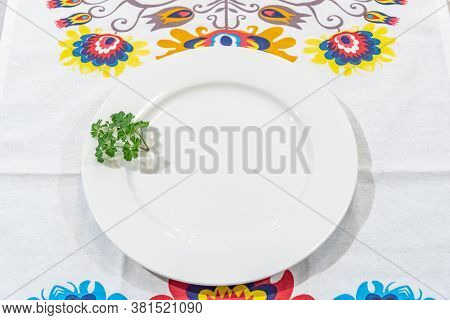 Plate On A Table With Lowicz Pattern Table Cloth