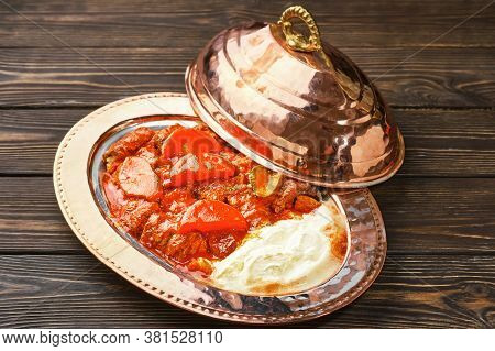 Iskander Kebab Is A Turkish Dish With Meat, Spices And Vegetables On A Traditional Copper Platter Ba