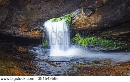 The Beautiful Waterfall In Forest.