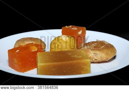Indian Sweets Served In White Plate. Halwa, Badusha, Ghee Mysore Pak, Laddu In Decorative Plate,