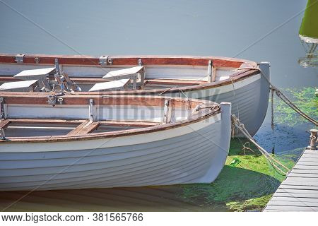 Two Boats Are Tethered At The Wooden Pier On The Volga River