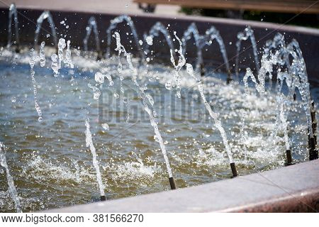Water Splashing In The Fountain. Freeze Motion Effect Achieved By Fast Shutter Speed Camera