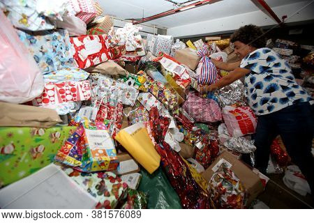 Salvador, Bahia / Brazil - December 13, 2017: Correios Employee Separates Gifts For Post Office Chri