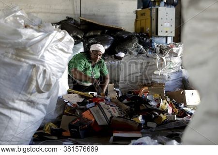 Feira De Santana, Bahia / Brazil - May 15, 2019: Woman Separates Recycling Material In A Recyclers' 