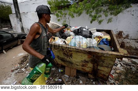 Lauro De Freitas, Bahia / Brazil - March 14, 2019: Man Is Seen Collecting Material For Recycling At 