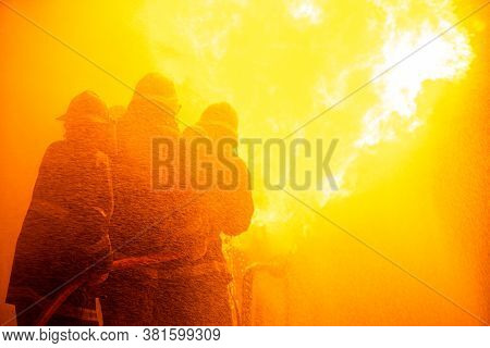 Operation Emergency Firefighter Spraying High Pressure Water To Fire, Professional Team Fireman Trai