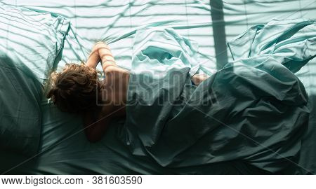 Kids Little Boy Is Laying Down And Sleeps On Pillow. Top View Of Child Sleeping Cozily On A Bed In B