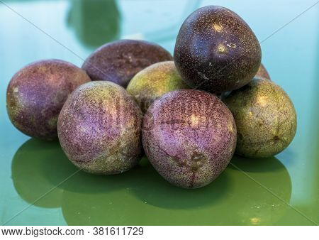 Pasiflora Fruits Or Passionfruit On Green Glass Table
