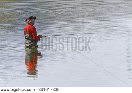 Oz-en-oisans, France, July 29, 2020 : A Fisherman At Work In The Waters Of Lac Besson At 2000 M High