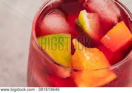 Close Up Of Sangria Drink In Glass With Ice And Fruit.