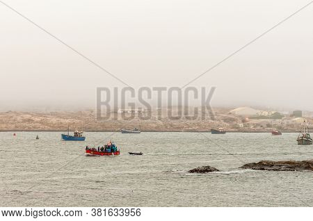 Luderitz, Namibia - June 14, 2011: A View Of Luderitz As Seen From Shark Island. Boats And People Ar