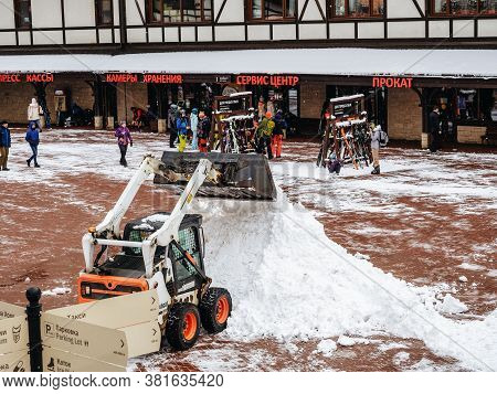 Sochi, Russia - 25 February 2020. A Tractor Clears Snow Raking It In A Heap In A Ski Resort Area