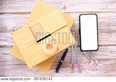 Delivery Box On Wood Table Background. Online Selling \nconcept