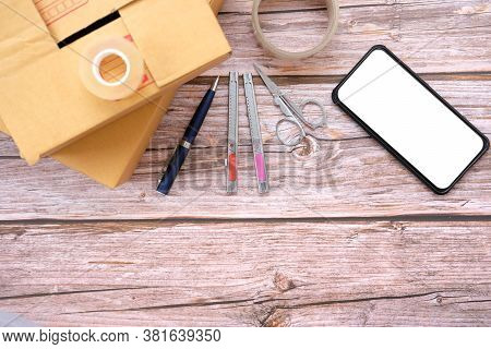Delivery Box On Wood Table Background. Online Selling \nconcept