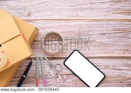 Delivery Box On Wood Table Background. Online Selling \nconcept