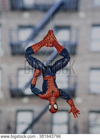 AUGUST 19 2020: superhero Spiderman hanging upside down from a web - Hasbro Legends action figure
