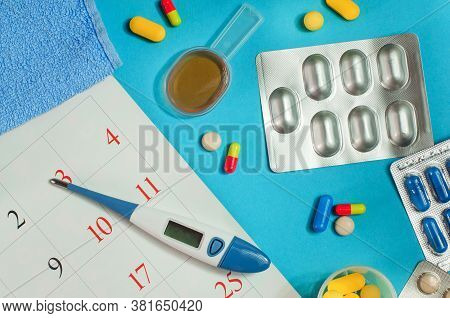 Pills, Spoon Of Syrup, Electronic Thermometer Near Calendar Page