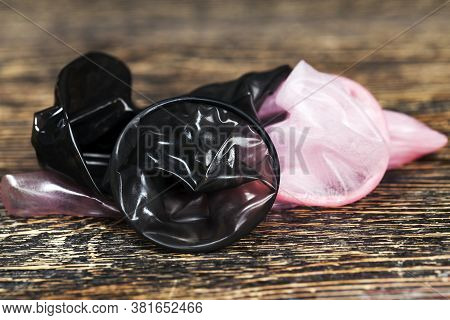 Two Quality Latex Condoms In Pink And Black, The Condom Is Not In The Package, Made Of Natural Latex